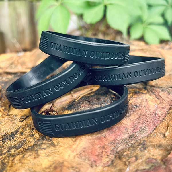 black bracelet with guardian outdoors division embossed on it