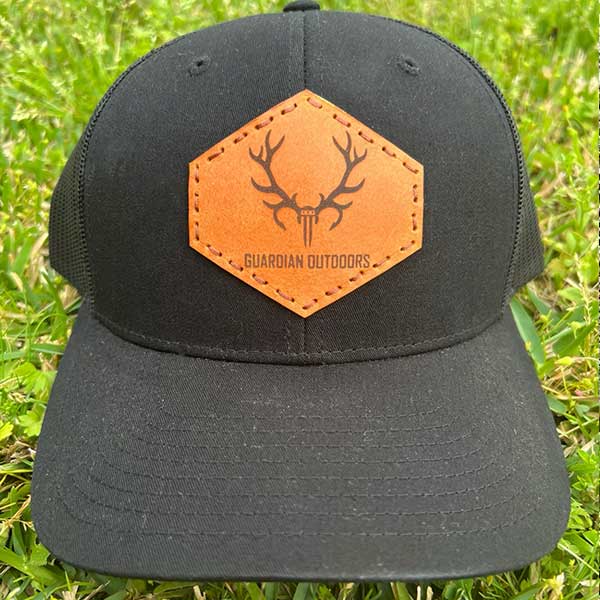 black hat with leather patch with guardian outdoors division logo stamped