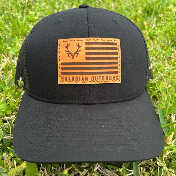 black hat with leather patch and logo flag stitched on front