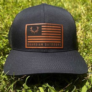 black hat with leather patch with flag and guardian outdoors written on patch